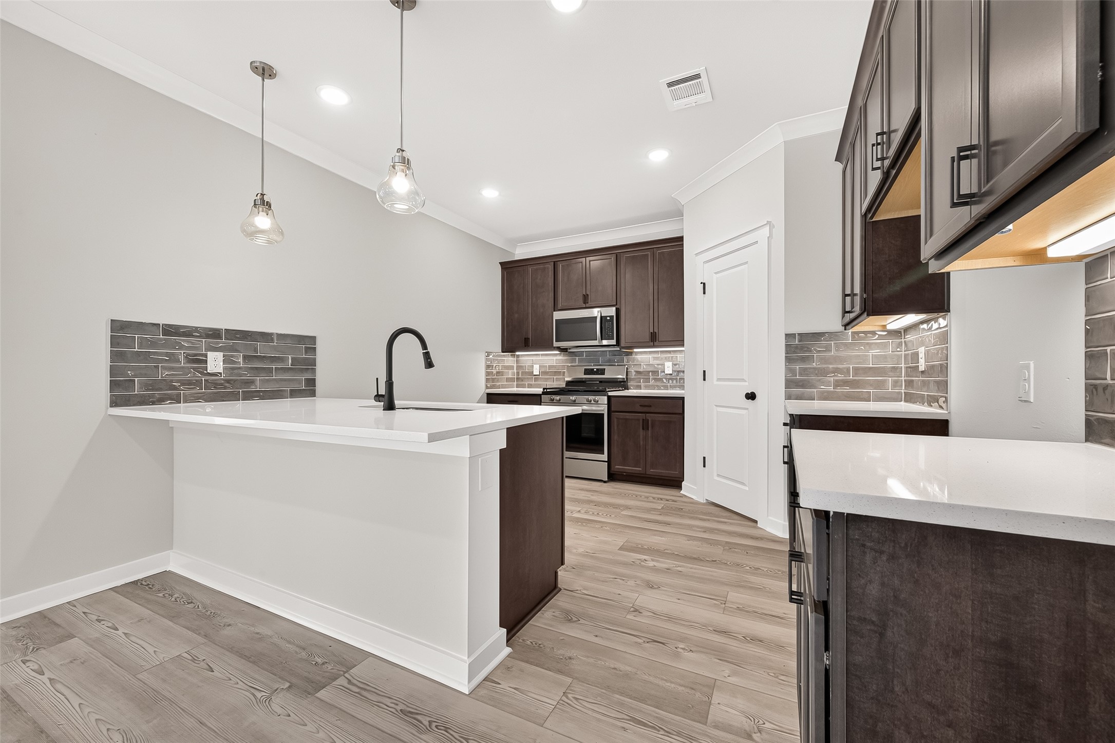 21122 Autumn Heights Rosharon, TX 77583 - Photo 13 of 42 a kitchen with stainless steel appliances granite countertop a sink a stove and a refrigerator
