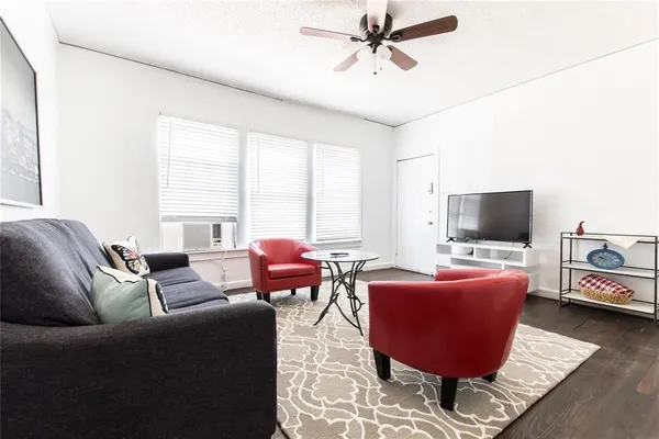 a living room with furniture or couch and a flat screen tv