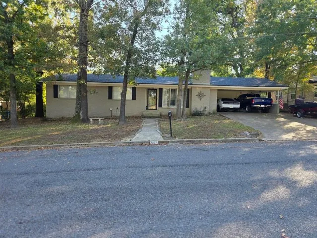 a view of a car park in front of a house