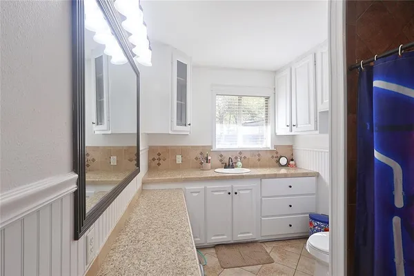 a bedroom with furniture and a window