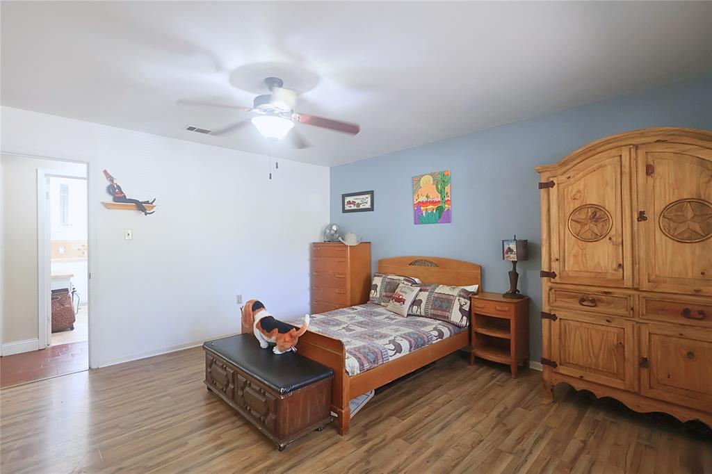 505 Colonial Drive Athens, TX 75751 - Photo 19 of 33 a bedroom with furniture and wooden floor