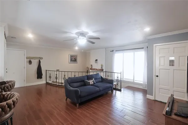 a living room with furniture a table and a potted plant