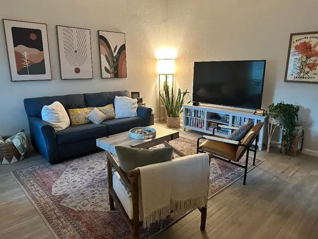 a living room with furniture and a flat screen tv