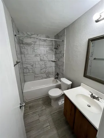 a bathroom with a double vanity sink toilet and shower
