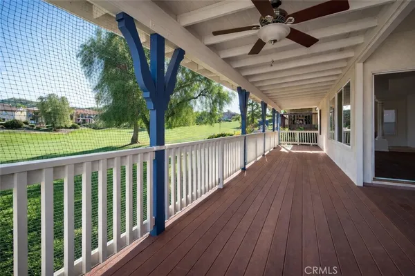 a view of a wooden deck with a big yard