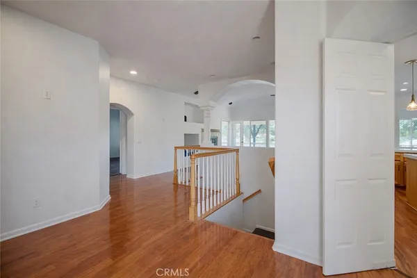 a view of a hallway with wooden floor and entryway