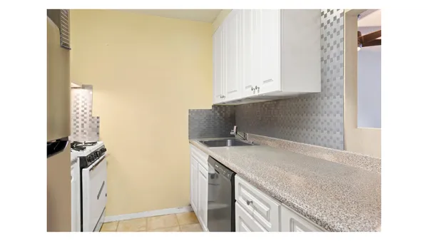 a kitchen with a sink and a refrigerator