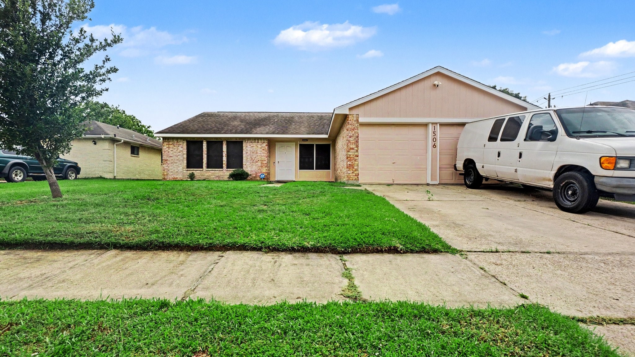 1506 Holbech Lane Channelview, TX 77530 - Photo 21 of 21 a front view of a house with a yard and garage