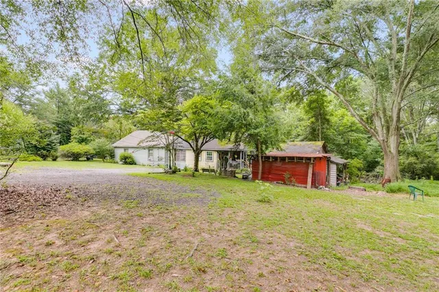 a view of a house with a yard and sitting area