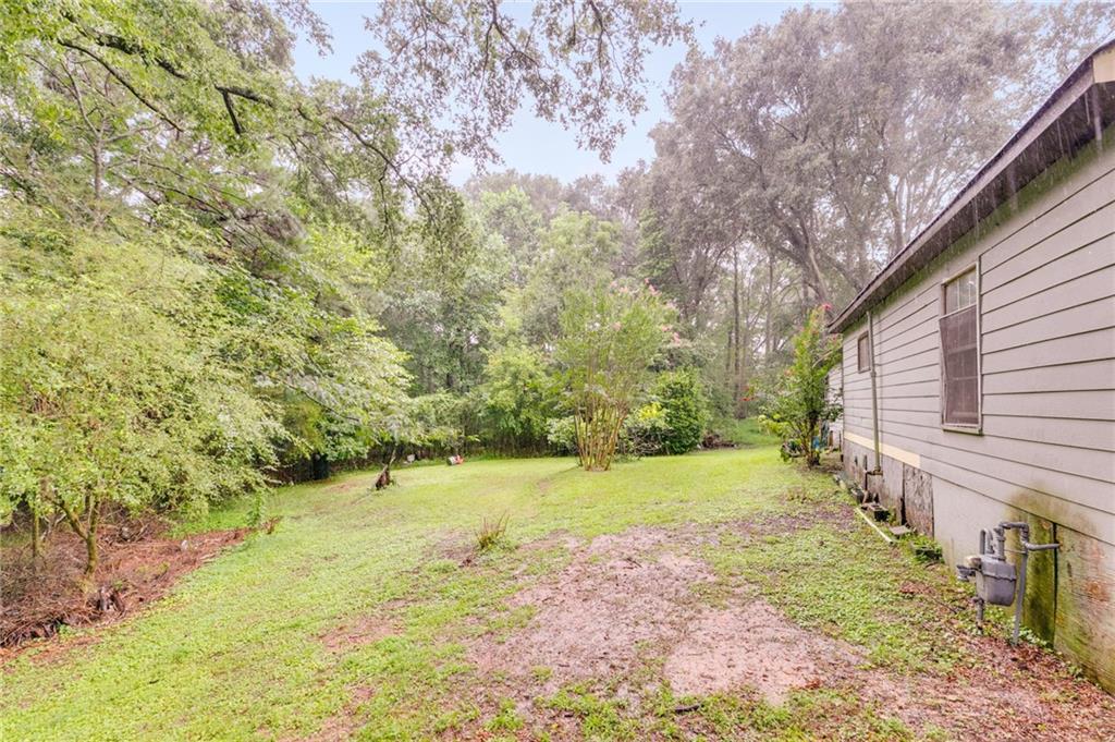 4661 Fowler Street Acworth, GA 30101 - Photo 4 of 16 a view of a yard with plants and large trees