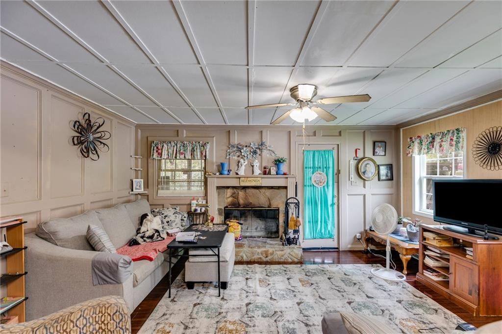 4661 Fowler Street Acworth, GA 30101 - Photo 6 of 16 a living room with furniture flat screen tv and a fireplace