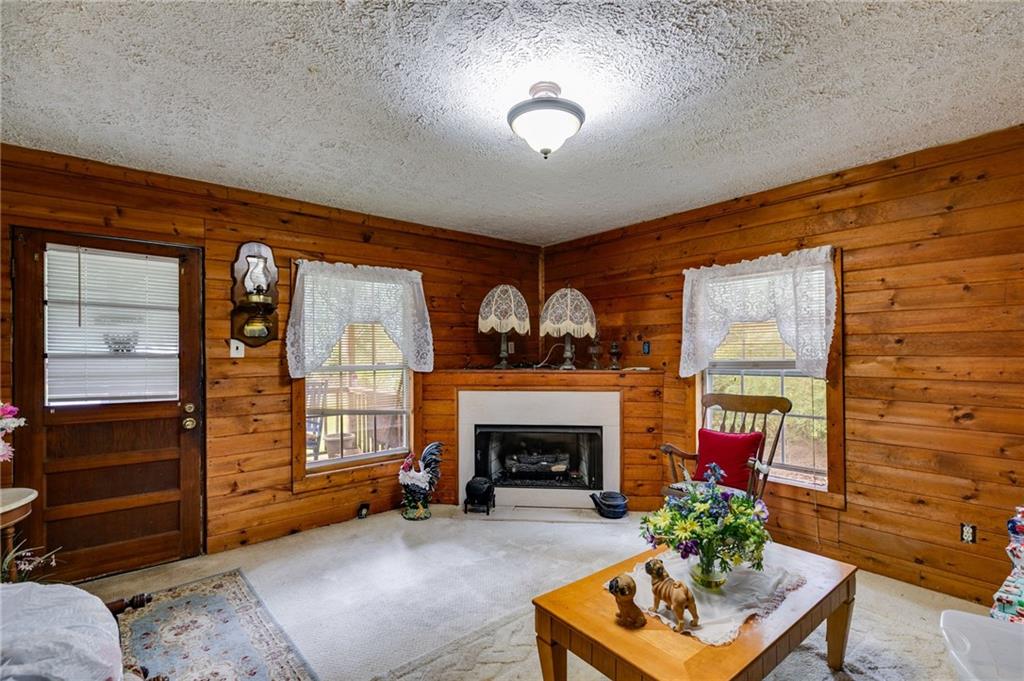 4661 Fowler Street Acworth, GA 30101 - Photo 10 of 16 a living room with furniture a fireplace and a window