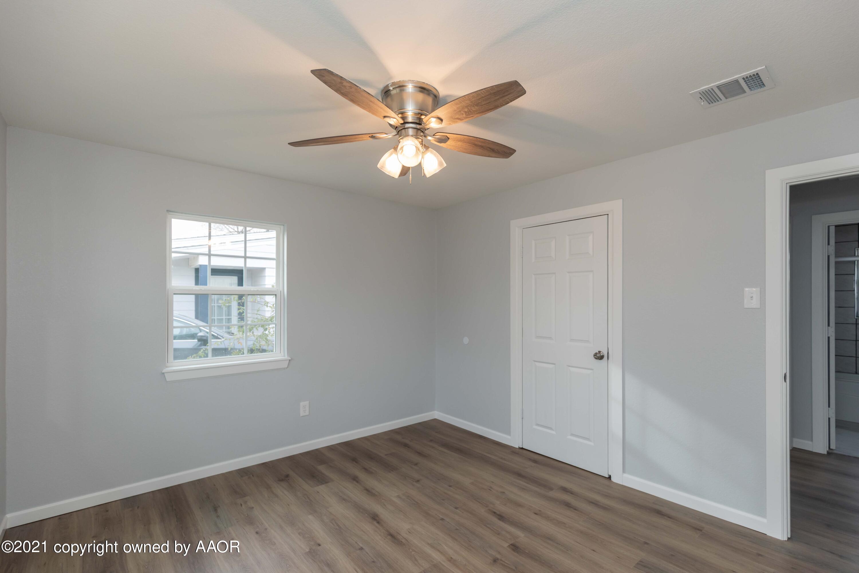 3808 Gables Street Amarillo, TX 79110 - Photo 15 of 23 a view of an empty room with window and wooden floor