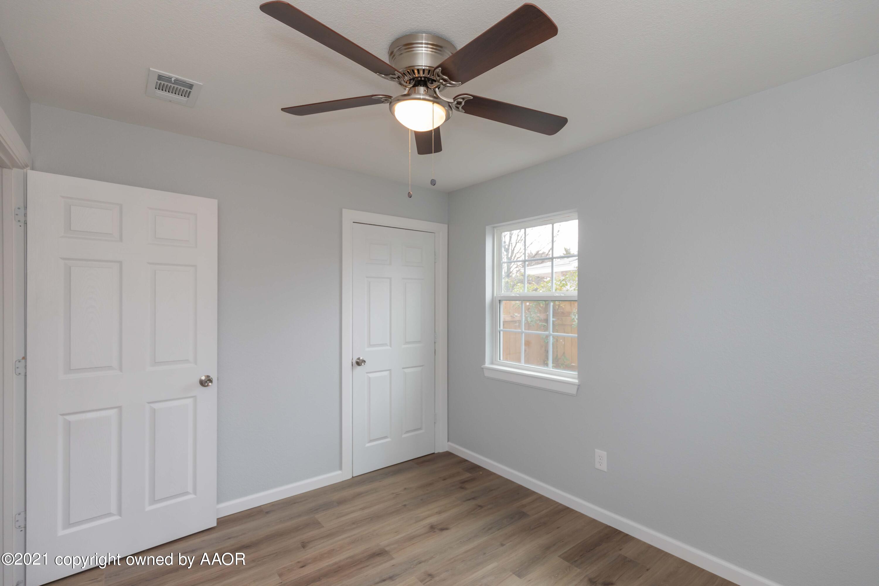 3808 Gables Street Amarillo, TX 79110 - Photo 17 of 23 wooden floor in an empty room with a window