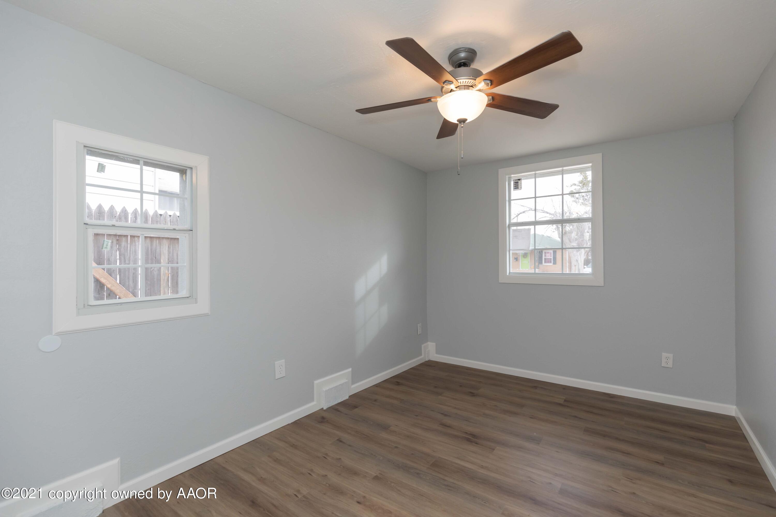 3808 Gables Street Amarillo, TX 79110 - Photo 21 of 23 an empty room with wooden floor and windows