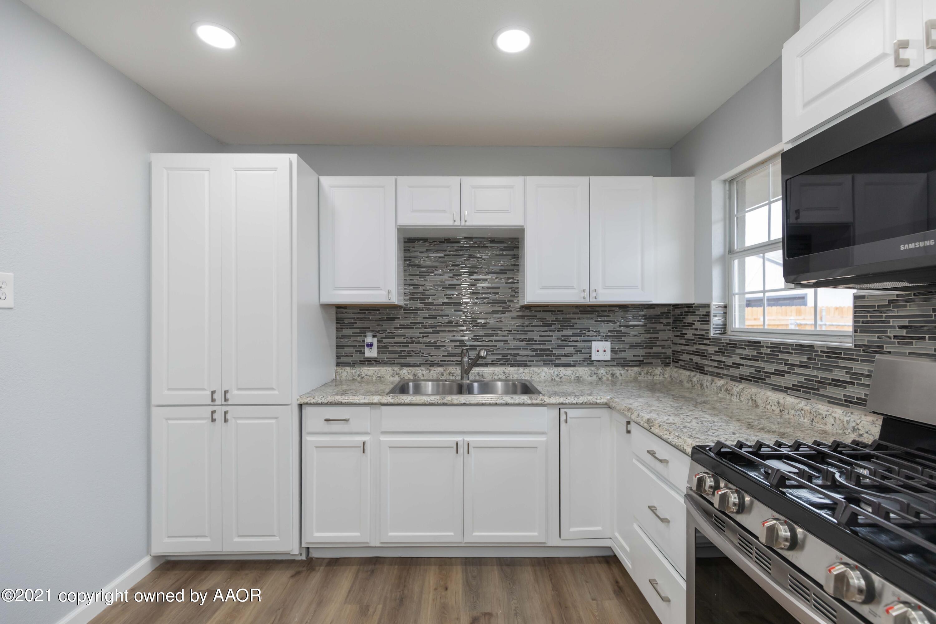3808 Gables Street Amarillo, TX 79110 - Photo 6 of 23 a kitchen with white cabinets and appliances