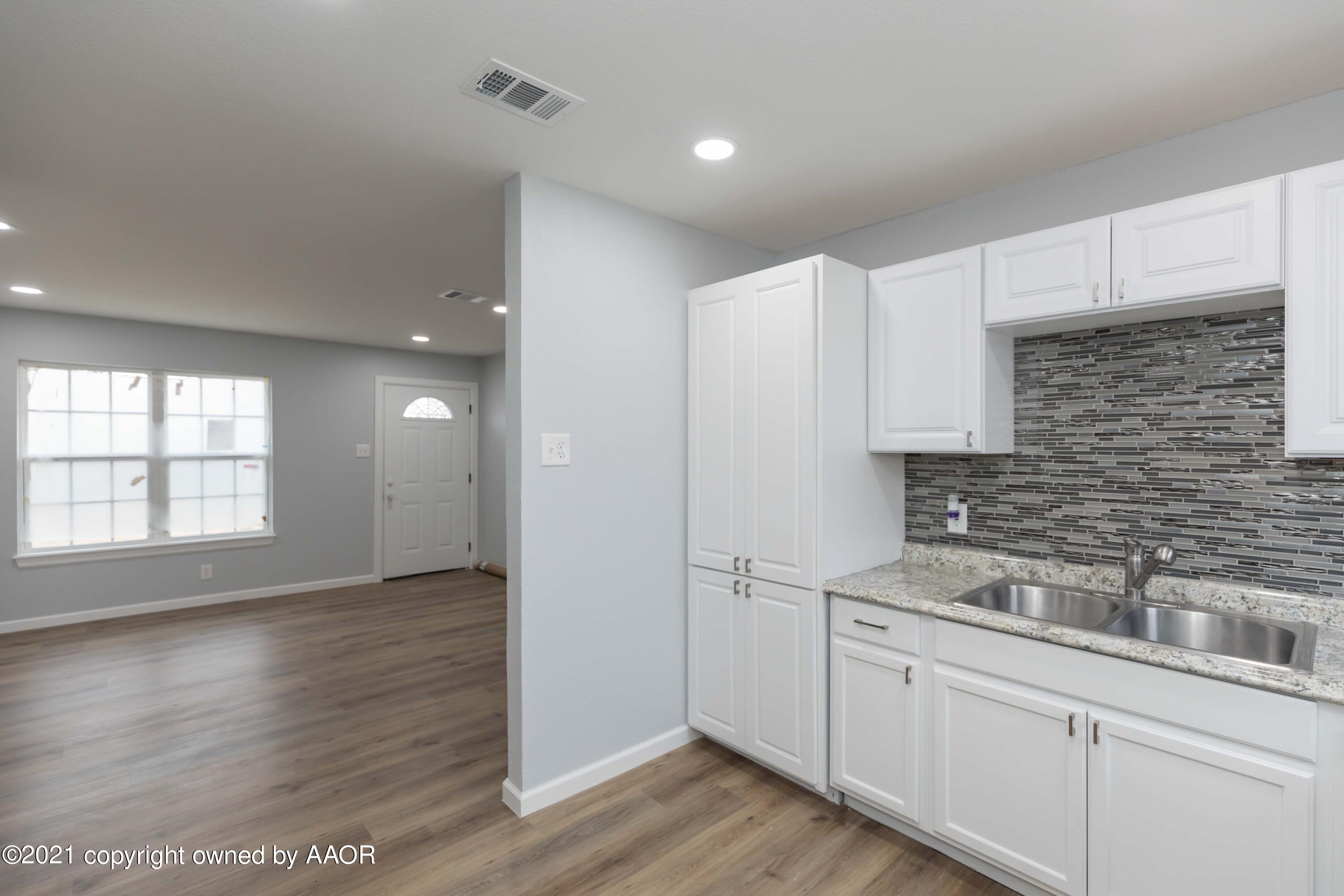 3808 Gables Street Amarillo, TX 79110 - Photo 7 of 23 a kitchen with a sink cabinets and wooden floor