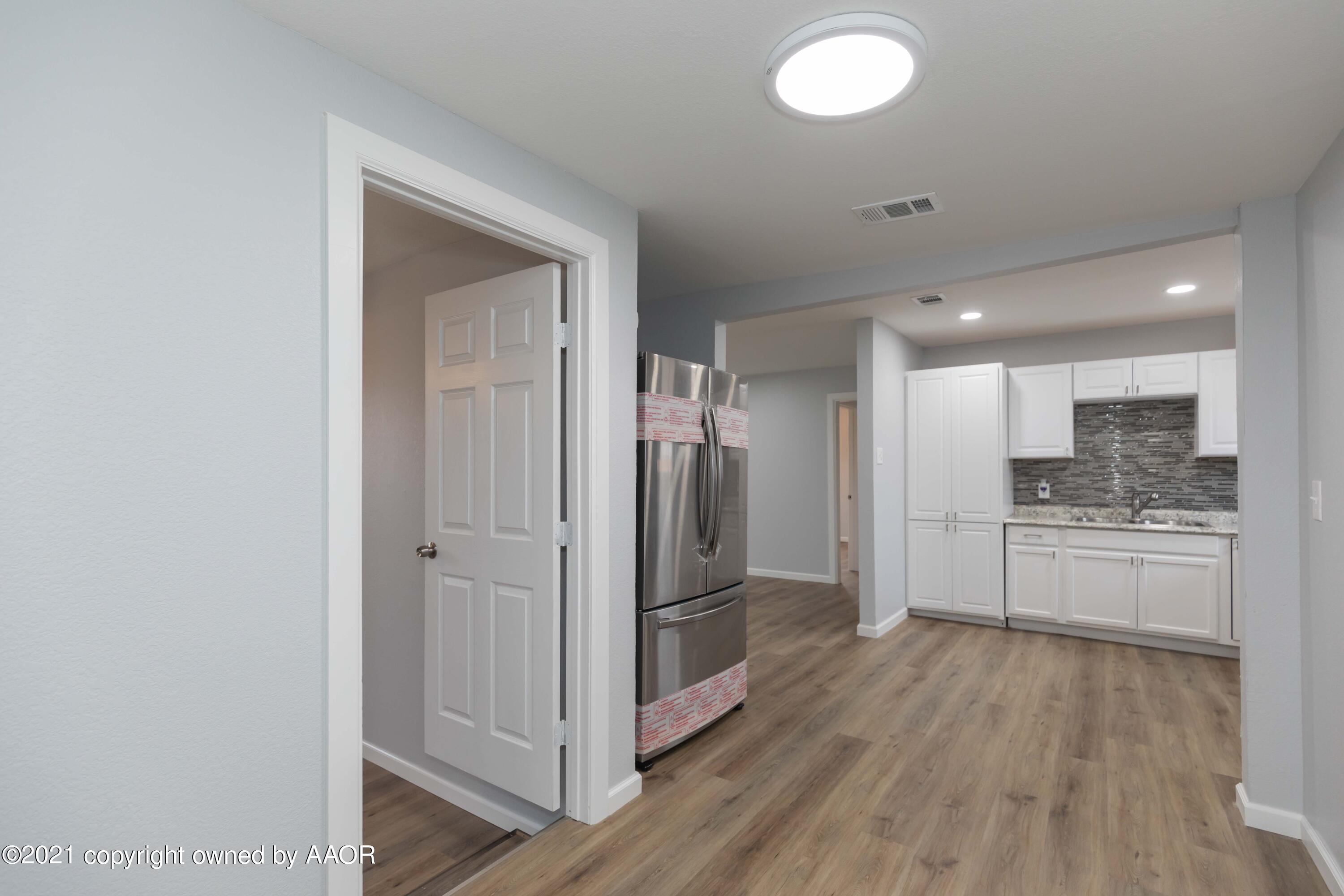 3808 Gables Street Amarillo, TX 79110 - Photo 8 of 23 a large kitchen with a refrigerator and a stove top oven