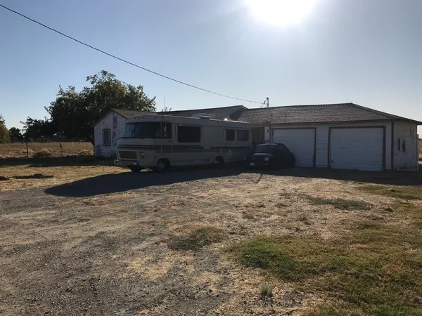 a view of a backyard of the house
