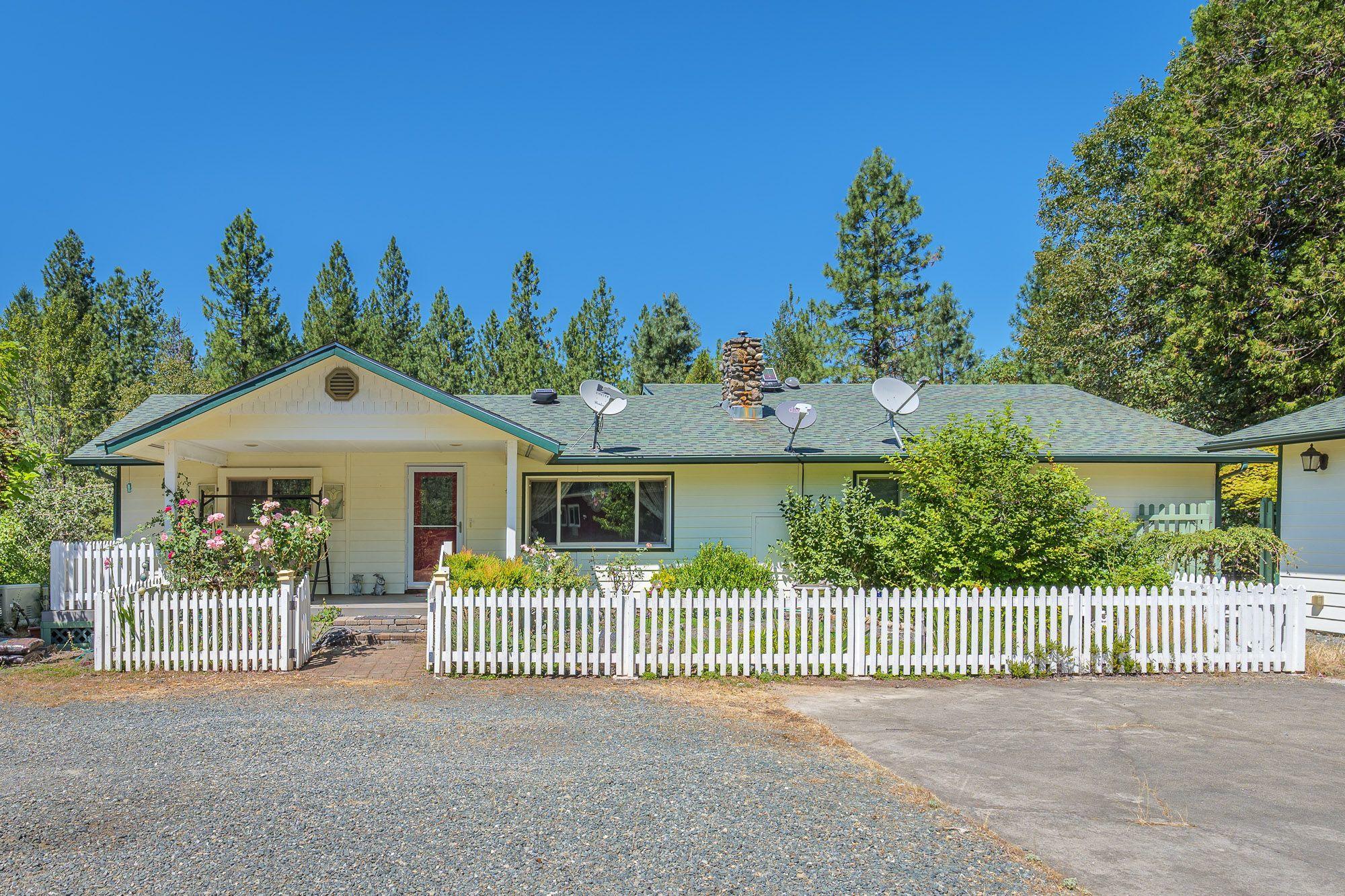 9266 Lower River Road Grants Pass, OR 97526 - Photo 5 of 39 a front view of a house with a garden and plants