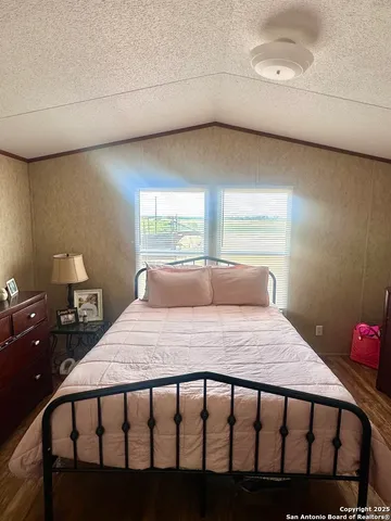 a bathroom with a sink a toilet a mirror and shower curtain