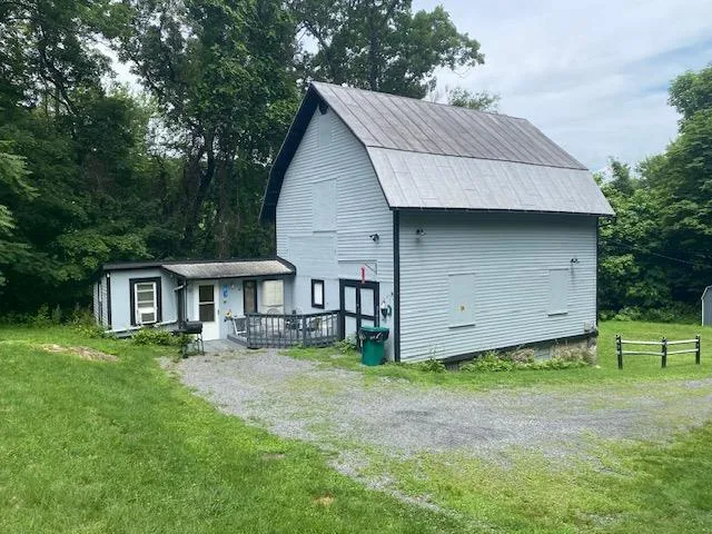 a front view of a house with a garden