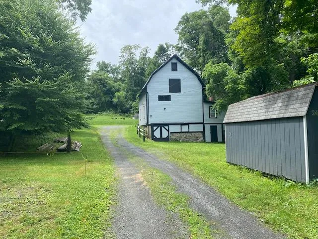 a view of a backyard with a garden and entertaining space