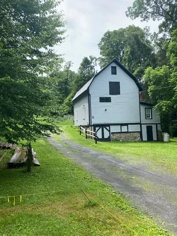 a house view with garden space and trees
