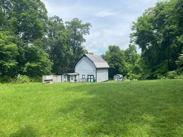 a house with green field in front of it