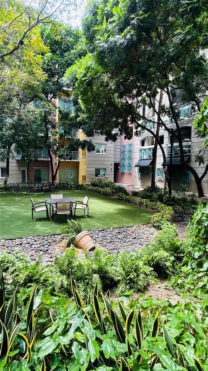 6001 Southwest 70th Street, Unit 127 South Miami, FL 33143 - Photo 7 of 13 a backyard of a house with lots of green space