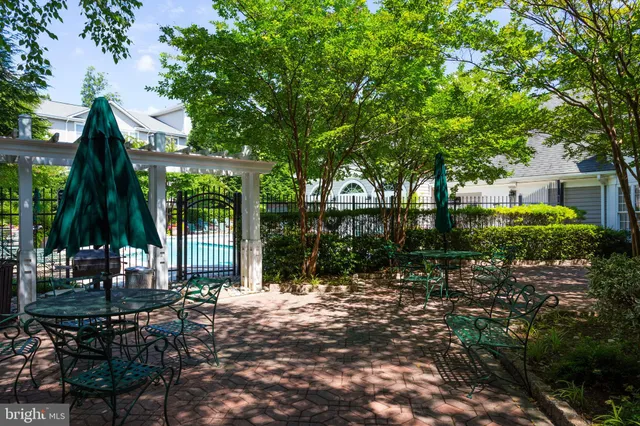 a backyard of a house with barbeque oven table and chairs