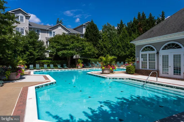 a front view of a house with swimming pool having outdoor seating