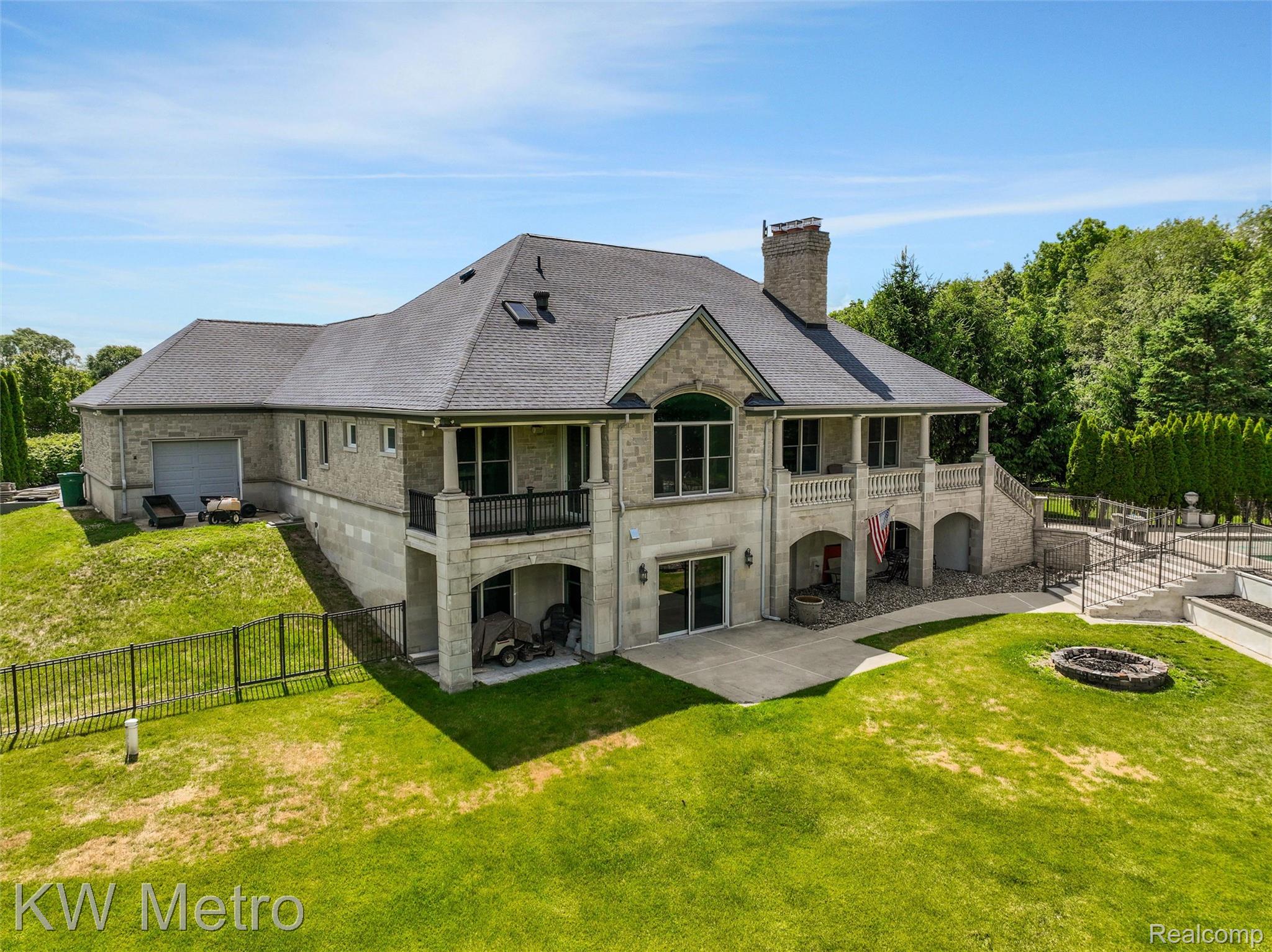65884 Windrose Court Ray, MI 48096 - Photo 11 of 82 Stone exterior with a shingled roof and multiple balconies