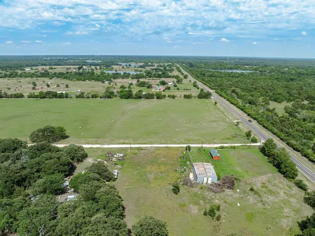 a view of a green field with an ocean