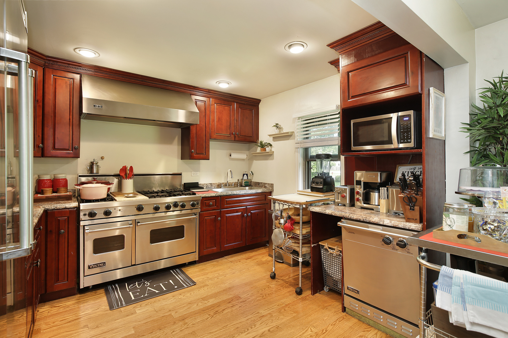 2015 Greenview Road Northbrook, IL 60062 - Photo 5 of 11 a kitchen with stainless steel appliances a stove a sink dishwasher and cabinets with wooden floor