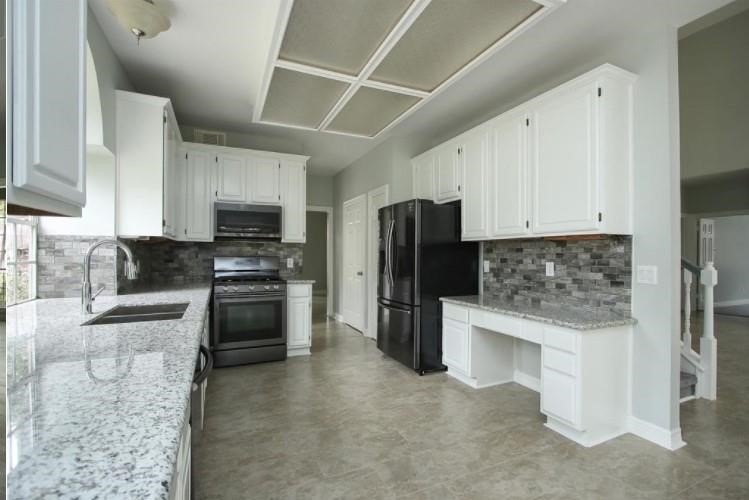 16222 Morningbrook Drive Spring, TX 77379 - Photo 12 of 44 a kitchen with stainless steel appliances granite countertop a refrigerator stove and sink