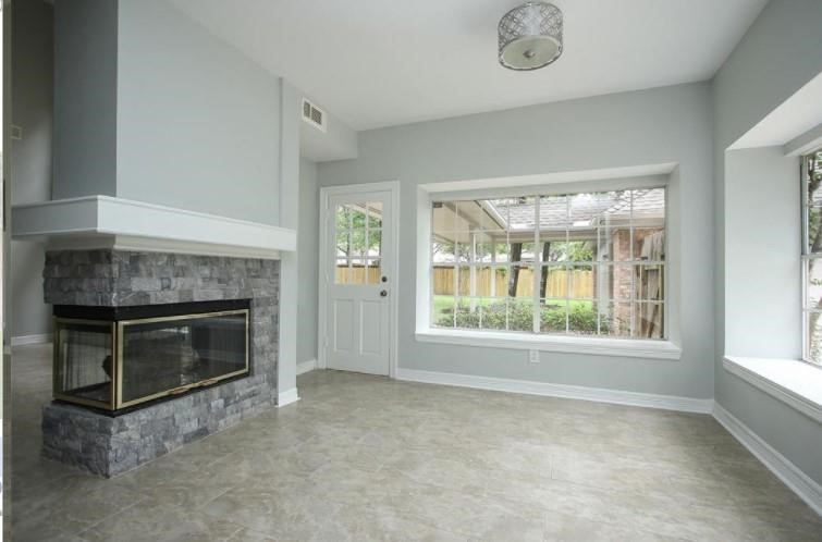 16222 Morningbrook Drive Spring, TX 77379 - Photo 14 of 44 a view of empty room with a fireplace