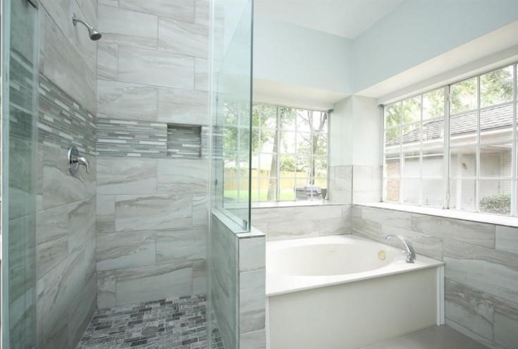 16222 Morningbrook Drive Spring, TX 77379 - Photo 23 of 44 a bath tub sitting in a bathroom next to a window