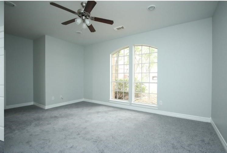 16222 Morningbrook Drive Spring, TX 77379 - Photo 26 of 44 an empty room with windows and ceiling fan