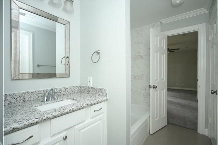 16222 Morningbrook Drive Spring, TX 77379 - Photo 27 of 44 a bathroom with a granite countertop sink and a mirror