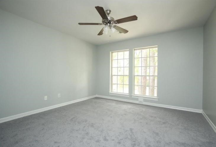16222 Morningbrook Drive Spring, TX 77379 - Photo 31 of 44 an empty room with wooden floor and windows