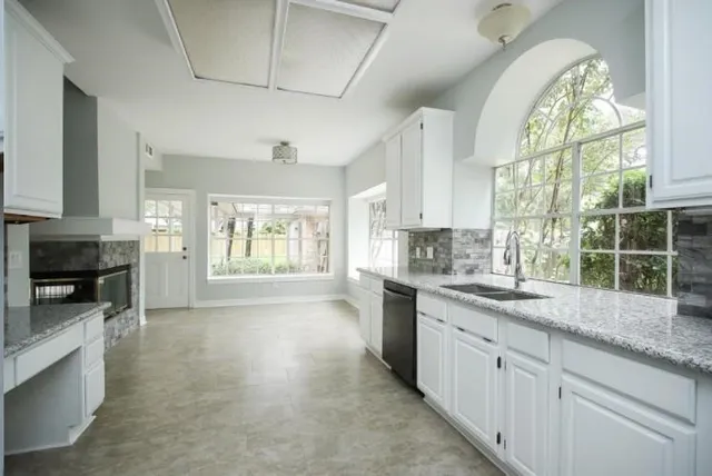 a kitchen with a sink stove and cabinets