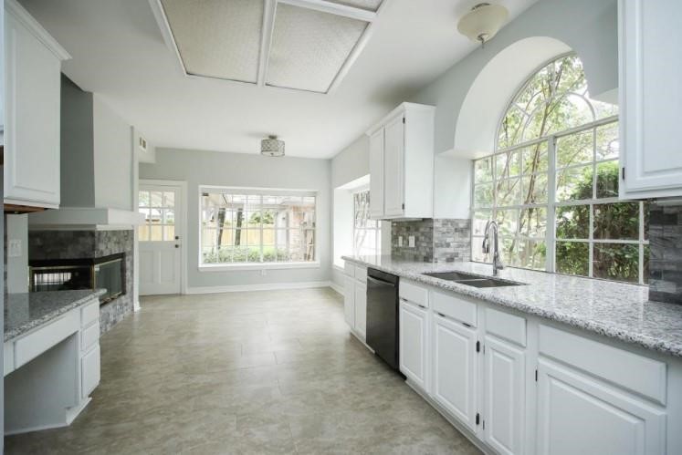 16222 Morningbrook Drive Spring, TX 77379 - Photo 5 of 44 a kitchen with a sink stove and cabinets