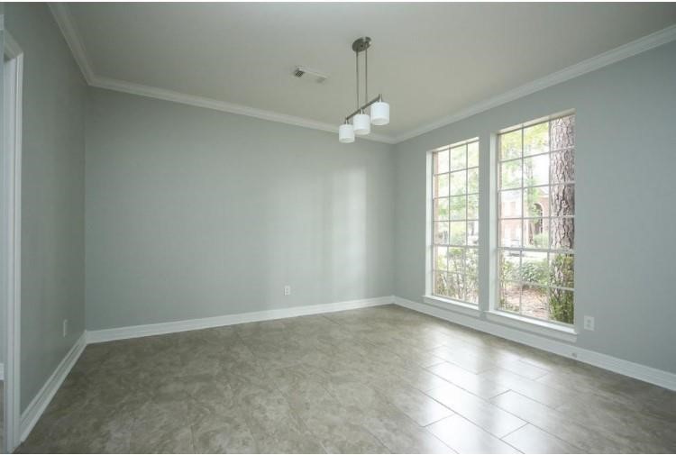 16222 Morningbrook Drive Spring, TX 77379 - Photo 10 of 44 an empty room with wooden floor and windows