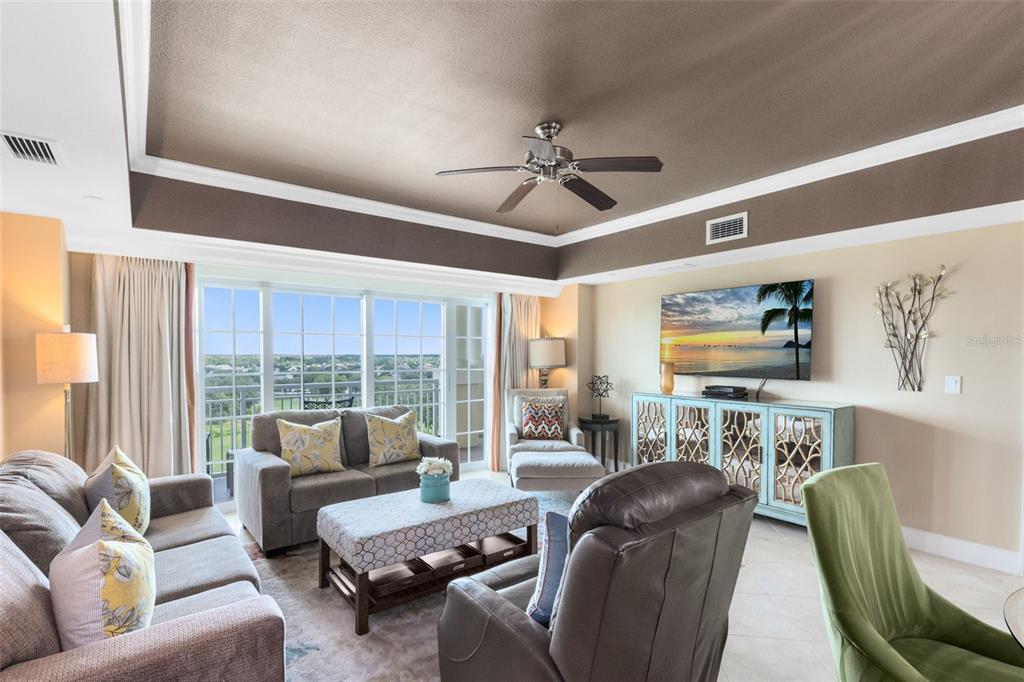 7593 Gathering Drive, Unit 501 Reunion, FL 34747 - Photo 25 of 38 a living room with furniture and a large window