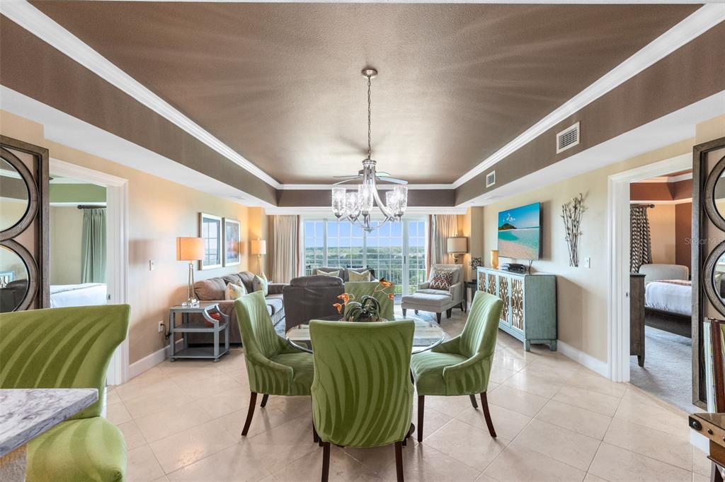 7593 Gathering Drive, Unit 501 Reunion, FL 34747 - Photo 7 of 38 a dining room with furniture a chandelier and wooden floor