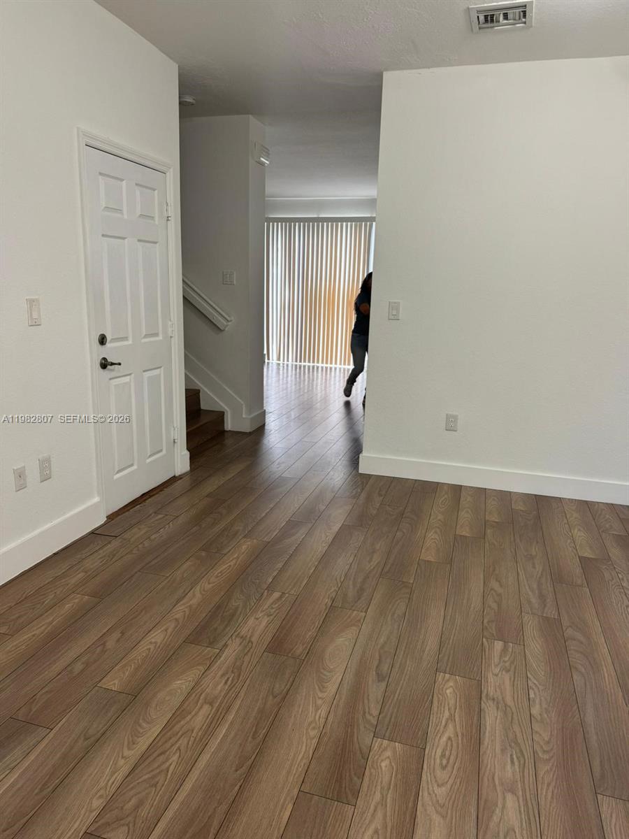 4217 Southwest 164th Court Miami, FL 33185 - Photo 2 of 15 an empty room with wooden floor & windows