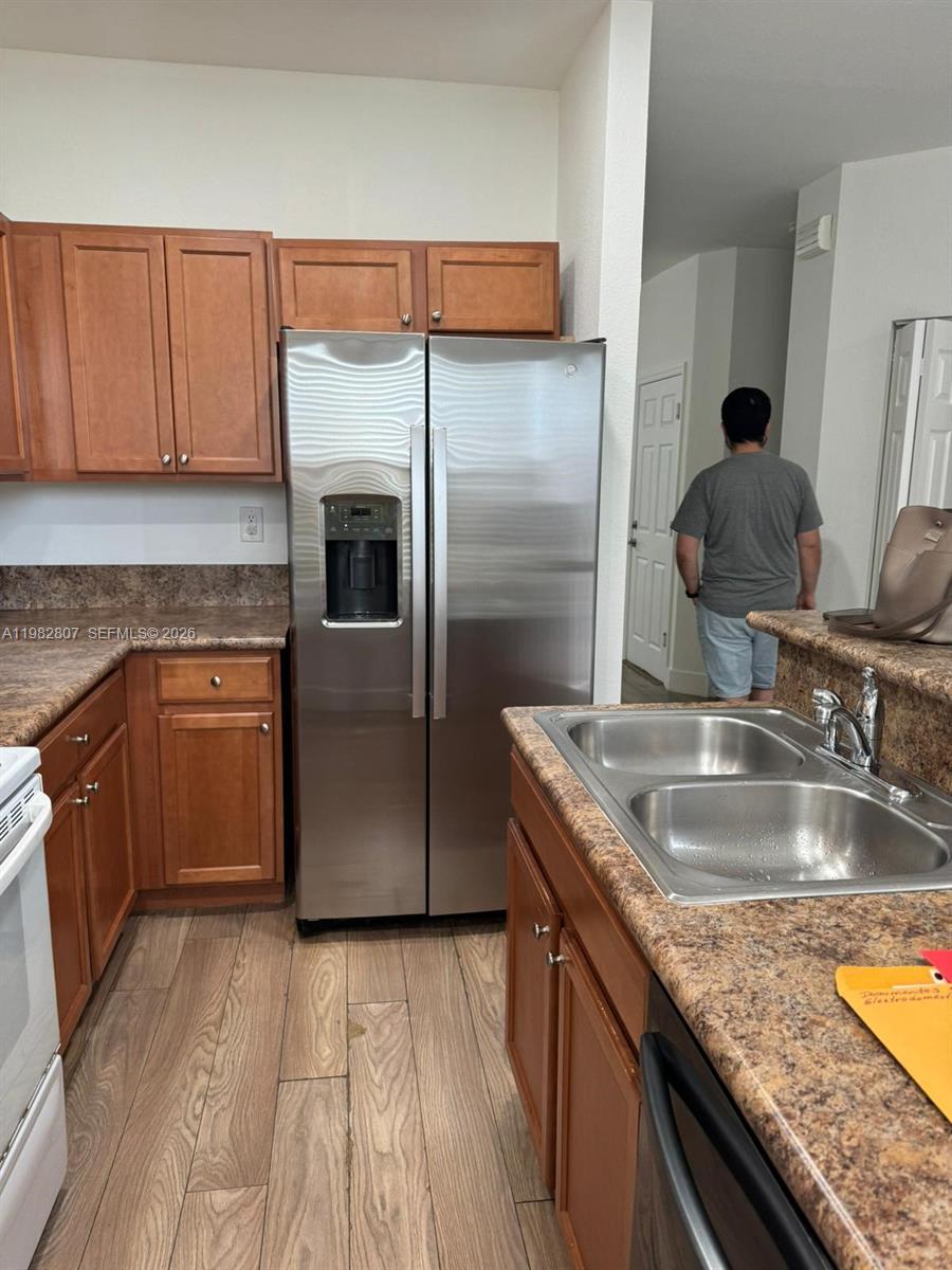 4217 Southwest 164th Court Miami, FL 33185 - Photo 3 of 15 a kitchen with kitchen island granite countertop a sink stove and refrigerator