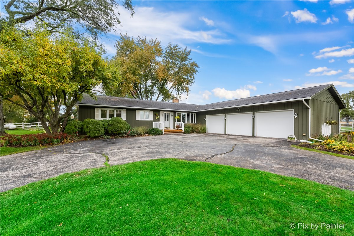 6709 Kemman Road Hebron, IL 60034 - Photo 1 of 4 a view of a yard with a house
