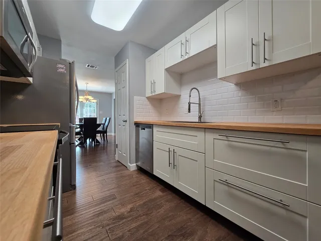 a bedroom with two beds lamp and a window